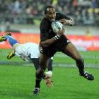 New Zealand's Joe Rokocoko slips a diving French tackle at Westpac Stadium. Credit:NZPA / Ross...