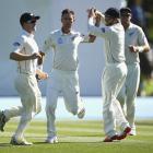 New Zealand's Trent Boult (2nd L) celebrates with teammates after taking the wicket of Australia...