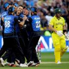 New Zealand's Trent Boult (C) is surrounded by teammates as they celebrate his dismissal of...