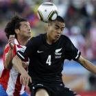 New Zealand's Winston Reid battles for the ball with Paraguay's Nelson Haedo Valdez during the...