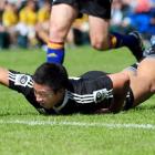 New Zealand Schools replacement back Jason Emery stretches out to score a try in the first half....