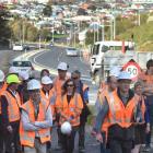 New Zealand Transport  Agency project manager Simon Underwood (fifth from the right) leads a...