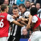Newcastle United's Joey Barton, second left, is pulled away from Arsenal's Gervinho, right,...