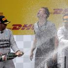 Nico Rosberg (R) and Lewis Hamilton splash each other with champagne after the Austrian Grand...