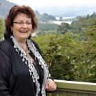 Nicola Taylor on the deck of her Purakaunui home, with its view across to the Mapoutahi pa site.