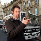 Night Bus Dunedin operator Andrew Rutherford with the rock he says was thrown through the window...