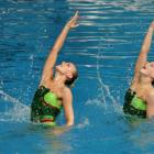 Nina (left) and Lisa Daniels compete in duel synchronised swimming. Photo from ODT files.