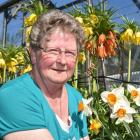 Nola Coburn in her garden with her flowering crown imperial fritillaries. Photo by Gregor...