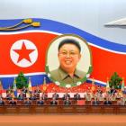 North Korean officials attend a national meeting to mark the 20th anniversary of late leader Kim...