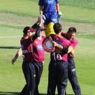 Northern Districts players celebrate winning the one-day final while a dejected Otago...