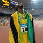 Nugget-fan Usain Bolt celebrates winning the gold and setting a new world record in the men's...