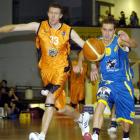 Nuggets guard Jamie Blake (right) and Harbour Heat forward Daryl Cartwright scramble after the...