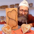 Oamaru baker Richard Vinbrux shows off his Mother's Day biscuits and the wooden mould used to...