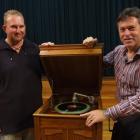 In working order . . . Antiques appraiser Hamish Walsh (right) views a late 1920s stand-up oak...