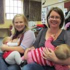 Angela Henderson and Ruby Henderson (9 months), of Weston, left, and Sonia Hudson and Rosie...