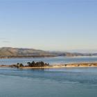 Oil tanker Kakariki heads into Otago Harbour past Harington Point (left) and The Spit. Photo by...