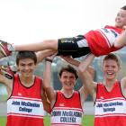 Oli Chignall is carried high by members of the winning John McGlashan senior boys team (from left...