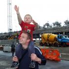 Oliver Hobbs (3), with father Tom, stretches towards one of the cranes on site at Forsyth Barr...