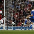 Olympiakos' David Fuster, far right, scores against Arsenal during their Champions League group F...