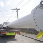 One of seven trucks carrying structural steel for the base section of one of two roof support...