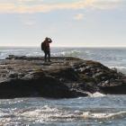 One of the search and rescue members searches for the two missing Owaka fishers. Photo by Hamish...