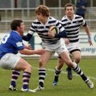 Otago Boys' second five-eighth Michael Collins pushes off Southland Boys' centre Kieran Short at...
