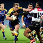 Otago captain Eben Joubert heads for the tryline in the tackle of North Harbour wing David...