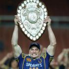 Otago captain Paul Grant holds the Ranfurly Shield aloft after his team beat Waikato in Hamilton...