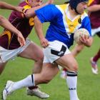 Otago centre Opini Toomalatai breaks through the tackle of Southland's Rocky Pettigrew at Tahuna...