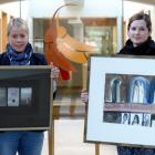 Otago Community Hospice chief executive Ginny Green (left) holds Timeshift by P. Smith and...