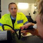 Otago Daily Times reporter Lea Jones takes part in a mock breath test for Constable Patrick...