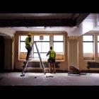Hamish Tyson (left) and Dale Soper repair windows in the former Dunedin Chief Post Office. Photo...