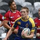Otago fullback Tony Ensor cuts through Tasman defenders, (from left) lock Filipo Levi, fullback...