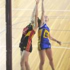 Otago goal shoot Greir Campbell tips the ball away from Waikato goal defence Jodi Beaumont during...