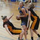 Otago Goldrush forward Patrice McKenzie (centre) powers her way between Waikato's Miriam Slatter ...