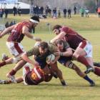Otago hooker Liam Coltman drives through a Southland tackler with the support of lock Joe Latta...