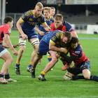 Otago hooker Liam Coltman is tackled by by Tasman first five Marty Banks. Photo Linda Robertson