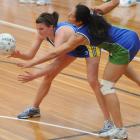 Otago midcourter Claire Kersten attempts to thread the ball past Canterbury players Jo McCaw ...