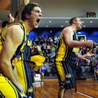 Otago Nuggets forward Tom Rowe (left), Riki Buckrell (obscured) and Sam King scream support to...