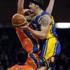 Otago Nuggets forward Tyler Amaya crashes into Southland Sharks defender Gareth Dawson (obscured)...