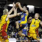 Otago Nuggets guard Sam To'omata glides to the hoop past Waikato Pistons defenders Tony Ronaldson...
