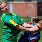 Otago player Sam Muirhead (right) cops it in the face from Central's Rosie Missen during their...