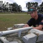 Otago Polytechnic stonemasonry student Garrett Clearwater, of Cromwell, places a cornerstone as...