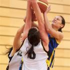 Otago's Jacqui Lodge (right) battles for the ball with two Taranaki Trojan defenders during the...