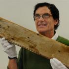 Otago Settlers Museum assistant conservator Laurence Le Ber with a  piece of graffiti from an...