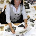 Otago Settlers Museum director Linda Wigley is surrounded by photographs of loved ones provided...