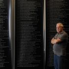 Otago Settlers Museum preparator Steve Munro stands in front of roll of honour panels being...