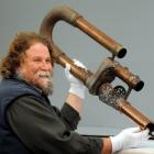Otago Settlers Museum senior conservator Francois Leurquin holds pneumatic tubes, once part of an...