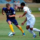 Otago United Youth midfielder William McIntyre is challenged by Aleem Sheik, of  Wellington Youth...