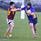 Otago Whalers forward Shane Unahi puts the fend on Southland Rams winger Zac Archer during the...